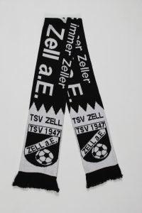 Schwarzer und weißer Strickschal mit dem Logo des TSV Zell 1947 und Fußballmotiv.