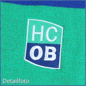 HCB Trikot in grün und blau mit gesticktem Logo auf der Vorderseite.