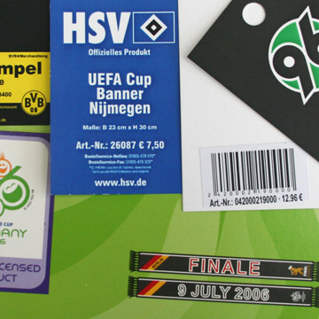 Verschiedene Hangtags und Etiketten, darunter ein offizielles Produkt von HSV und ein UEFA Cup Banner.